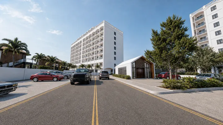 Arrival street beside the residences and a small gabled entrance pavilion