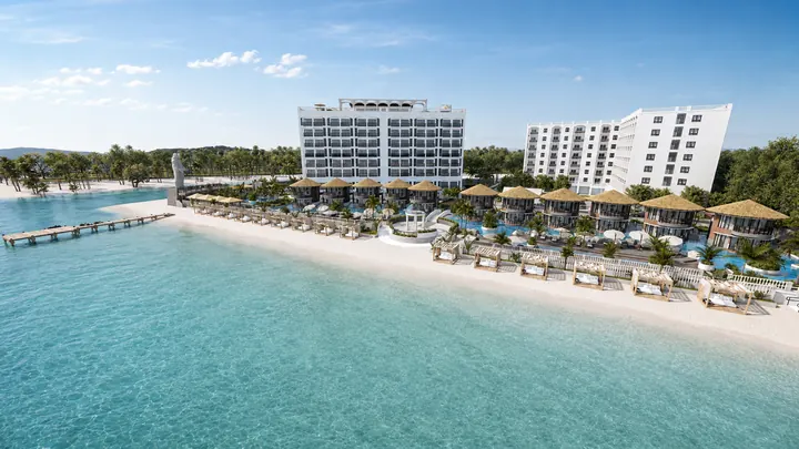Del Mar beachfront with white residences, thatched villas, cabanas and a timber jetty