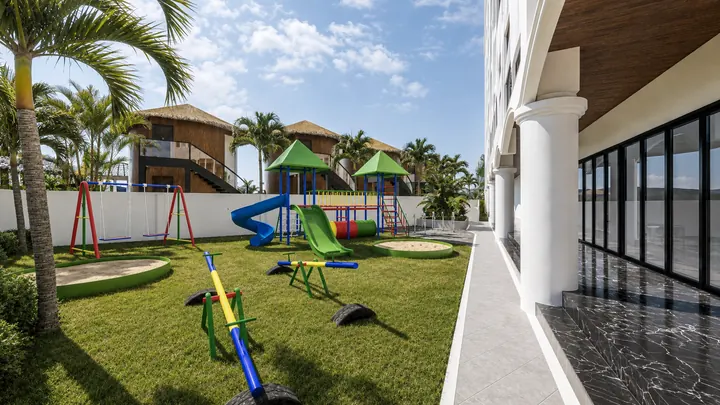 Children’s garden with swings, slides, seesaws and sandpits beside the hotel colonnade