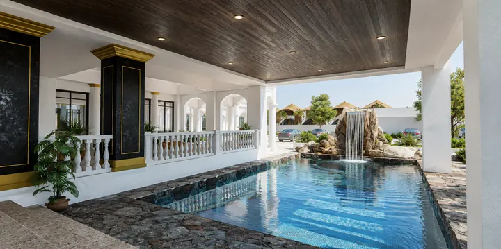 Covered pool beneath a timber ceiling with black marble columns and a rock waterfall