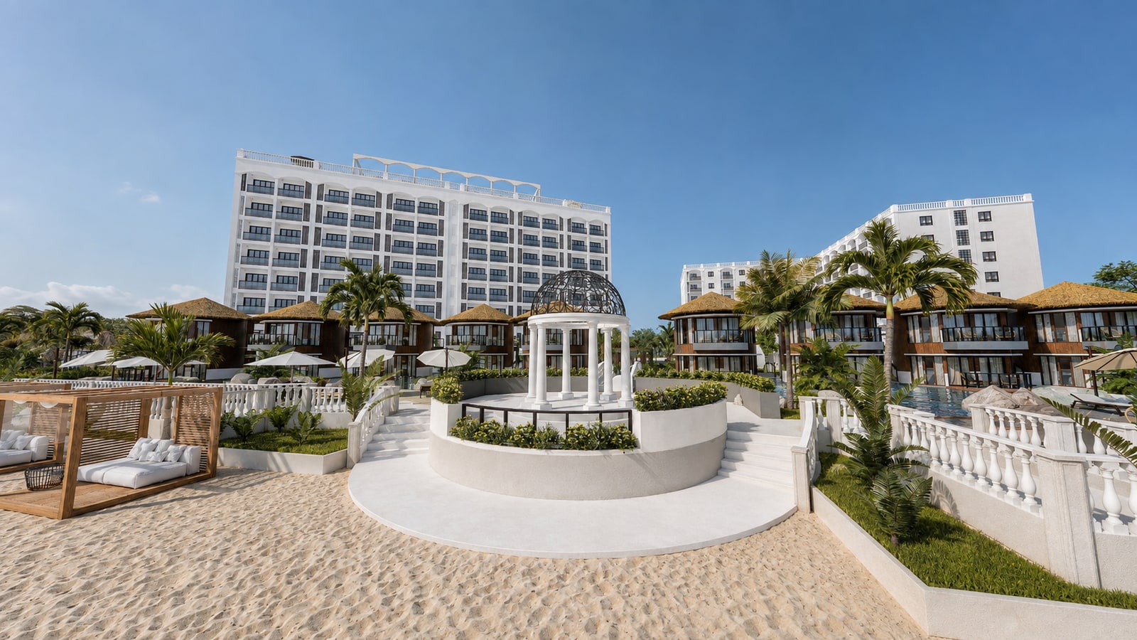 White beachfront rotunda with an open ornamental dome, curved stairs, palms and the villas and residences rising behind.