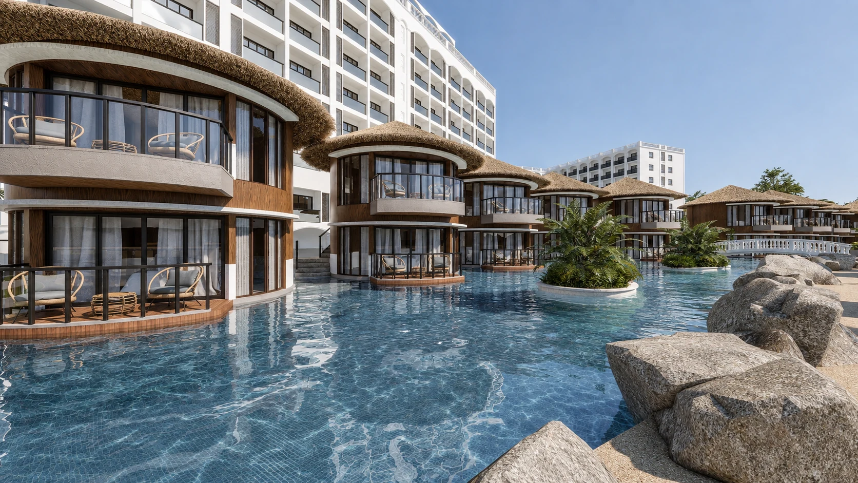 Del Mar thatched villas opening onto the lagoon pool beside a white footbridge