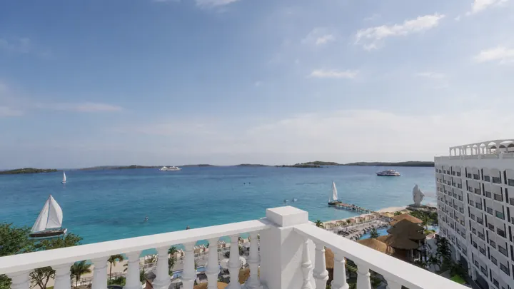 Bay view from a white balustraded rooftop terrace above the beachfront villas
