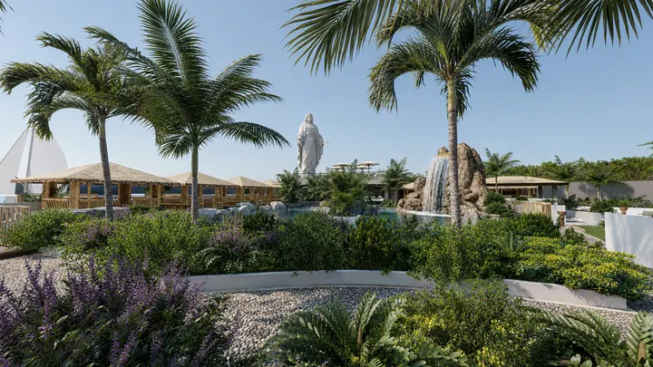 Tropical flower beds and pebble paths facing the waterfall, gazebos and white statue